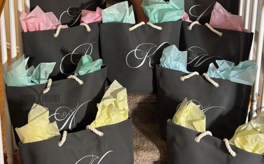 Woman sitting on a staircase with personalized tote bags for gifting to her bridesmaids.