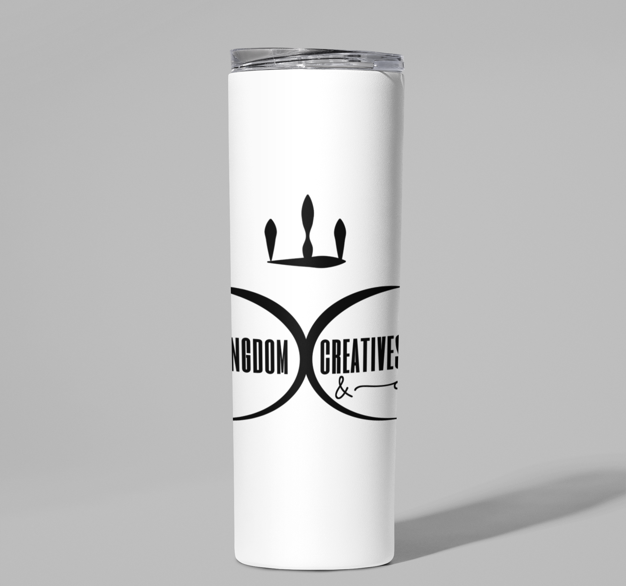 White tumbler with the Kingdom Creatives & Co. logo on a gray background